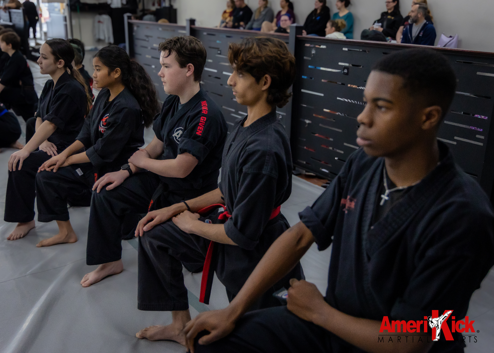 Amerikick Pennington students kneeling at attention